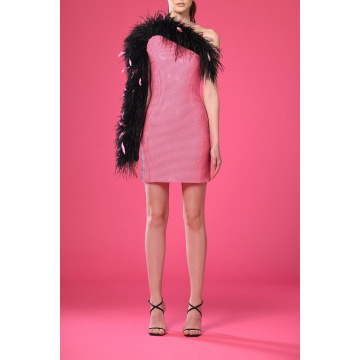 Short pink dress with black rhinestones and feathers